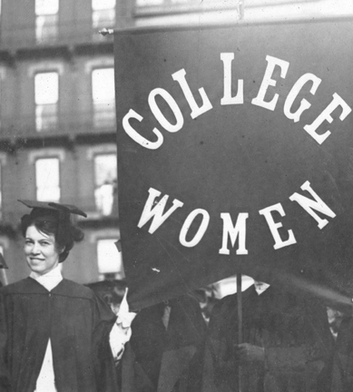 smiling woman in mortarboard with College Women flag